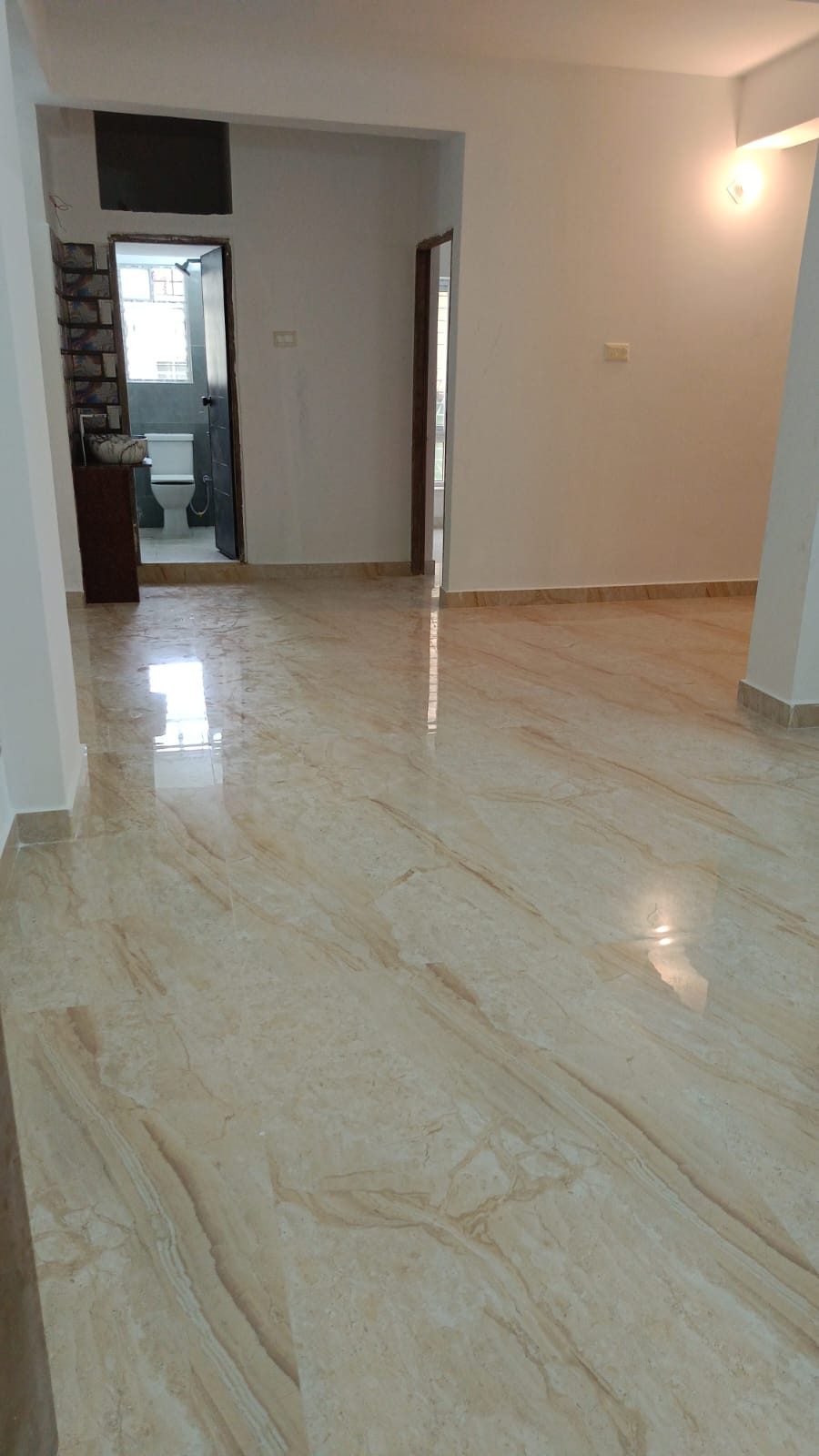 Spacious hallway with polished marble flooring in a flat at Krishna Kamdhenu, Kestopur