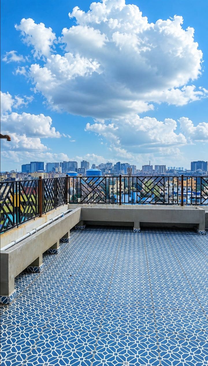 Blue-tiled terrace with a city skyline view at Krishna Kamdhenu, Kestopur